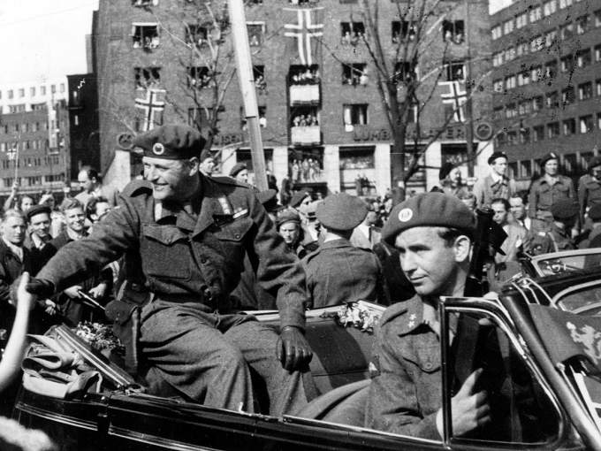 13. mai 1945 kom Kronprins Olav tilbake til Norge. Krigshelten Max Manus var væpnet livvakt i forsetet, Scanpix/NTB